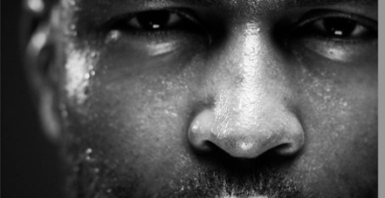 a man with a beard who is sweating