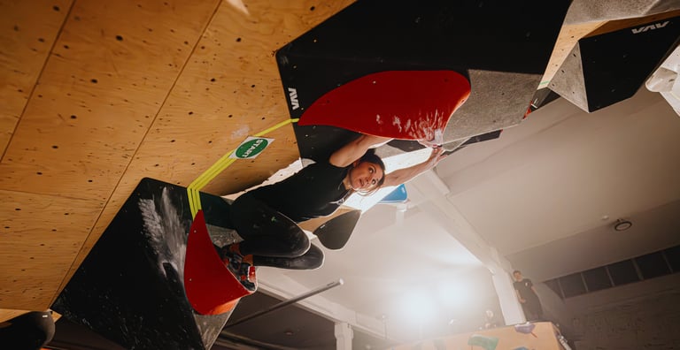 woman climbing in a bouldering competition