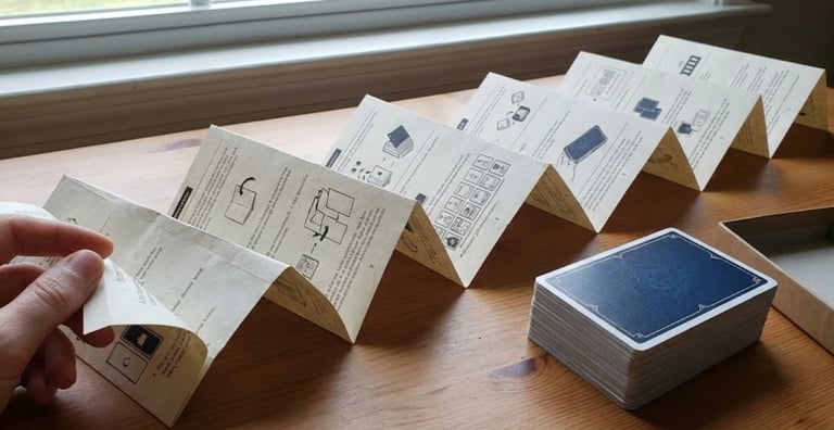 Accordion fold rulebook paper for micro card games.