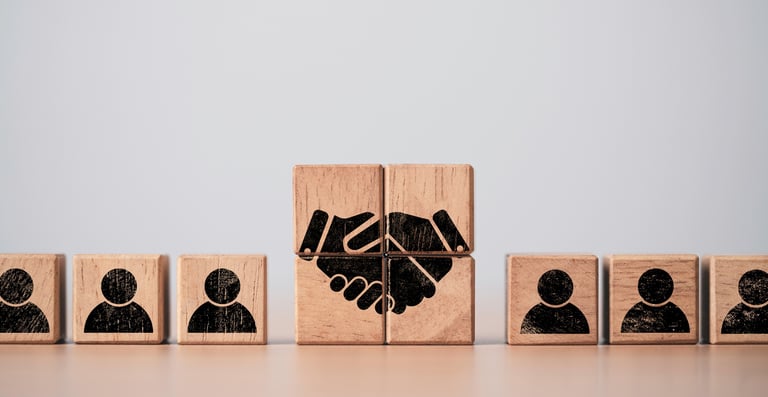 Wood Blocks Forming a Handshakre and with Outlines of People on Each Side 