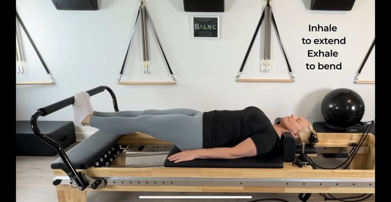 a woman working footwork on the reformer for rehabilitation