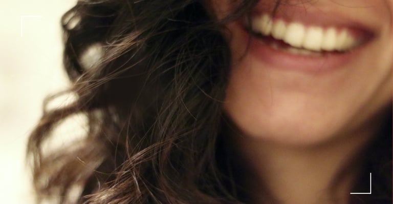 a woman with long hair and a smile on her face