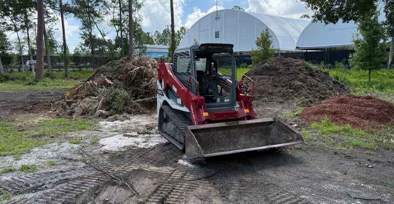 a tractor with a loader on a dirt road