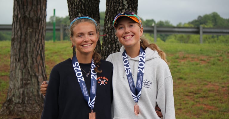 Maija and Anna Andert wearing bronze medals at 2025 Southeast Regionals