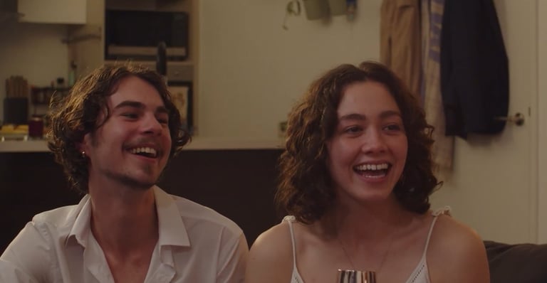 a man and woman sitting on a couch