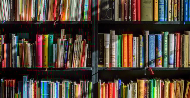 Personal bookshelf filled with books that shaped leadership thinking and perspective
