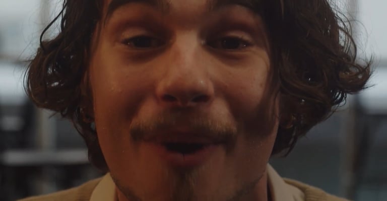 a man with a mustache and a tie on his neck