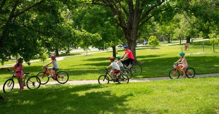 Group of children biking through the park