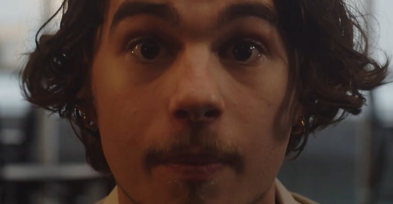 a man with a mustache and a tie on his neck