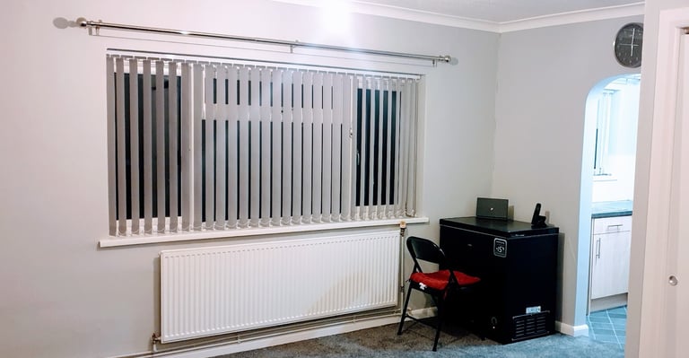 a vertical blind and curtain pole fitted in Lymington