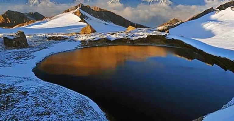 Ansoo lake surrounded by snow covered mountains