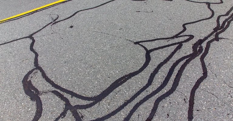 Sealing cracks using professional machinery, expanding the longevity of the asphalt