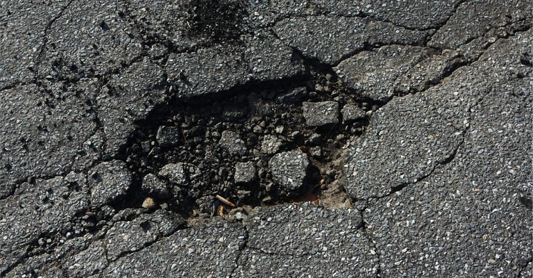 Crumbled pothole example that needs repaired