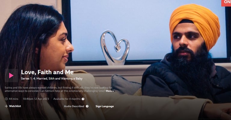 Screenshot of a BBC iPlayer show with two people talking on a sofa.