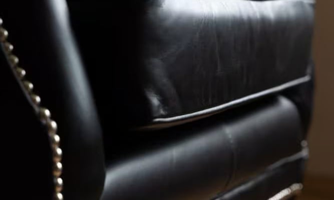Black leather chair with metal pins