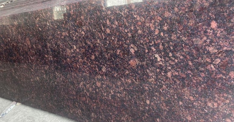 Polished Tan Brown granite slab with dark mahogany and black flecks for luxury kitchen countertops.