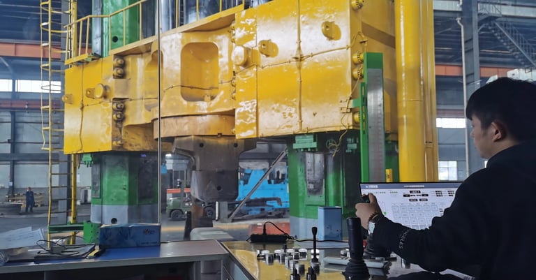 Heavy industrial forging press operated by technician in manufacturing workshop.