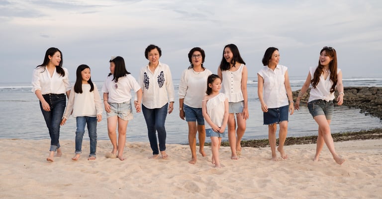 Large family gathering near the coastline during a family photography session at The Ritz-Carlton Bali