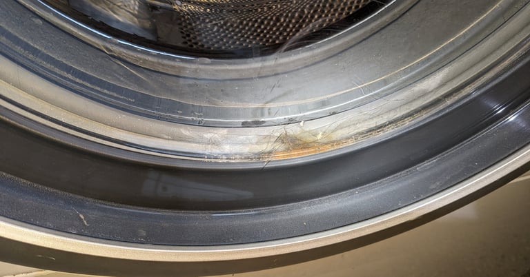 Front load washer door with stuck hair