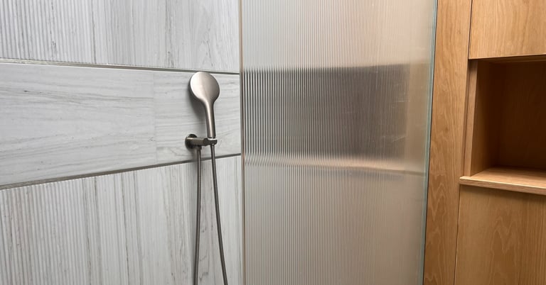 fluted tiles and oak in shower room