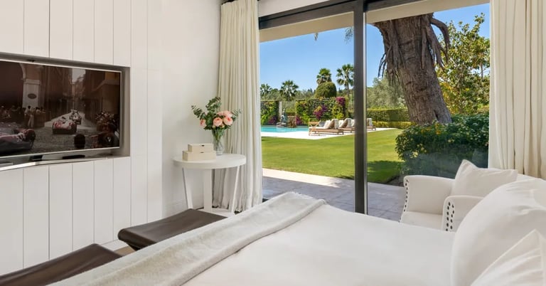 Guest suite with garden views and modern interior design at Villa El Olivo, Marbella