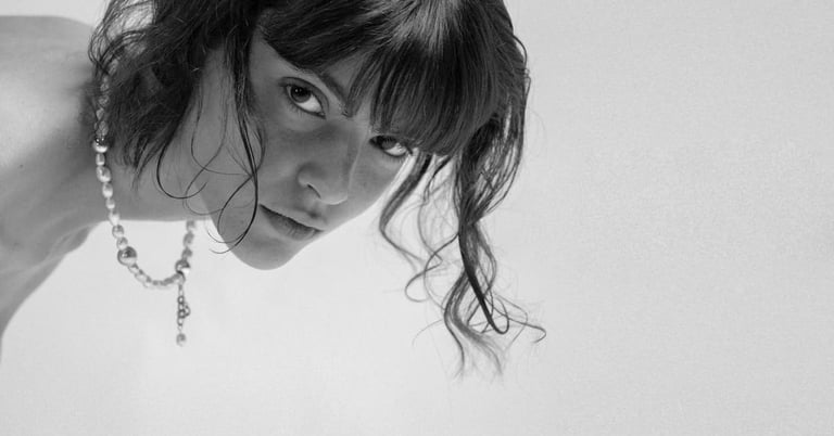 Model wearing a fun.arc.ik. classic pearl necklace, captured in a close-up black-and-white portrait.