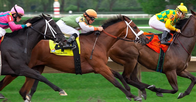 horses racing on racetrack jockeys with whips