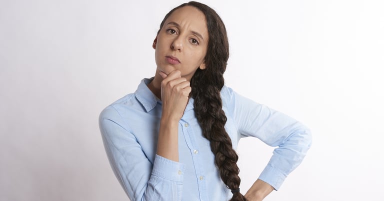 woman thinking thoroughly and wondering if gold ira is a scam