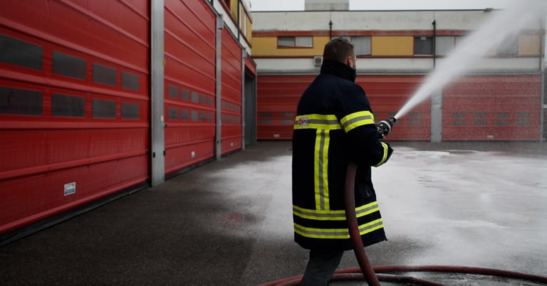 a firefighter in a fire hydrant spraying cafs foam