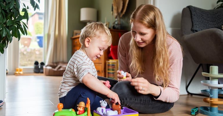 Speech Therapist Chloe Parikh playing with farm animals with child