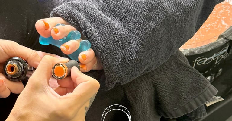Wet foot full pedicure service with gel orange toe nails by The Nail Witchery