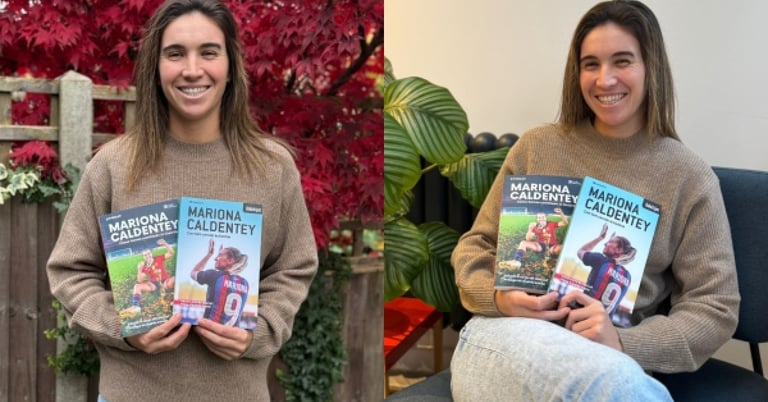 two women holding up their books and smiling