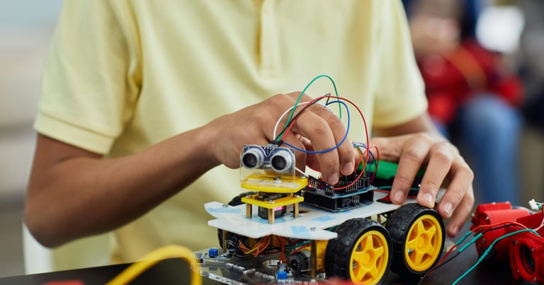 a kid is holding a remote control car