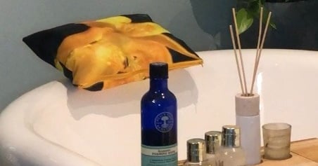 a bathtub ready for spa experience complete with waterproof bath cushion with yellow floral print