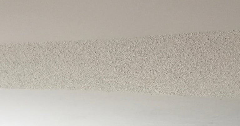 Image of a popcorn ceiling in the midst of being removed