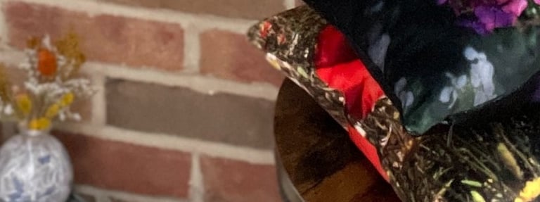 stack of handmade velvet cushions with vibrant floral photographic prints