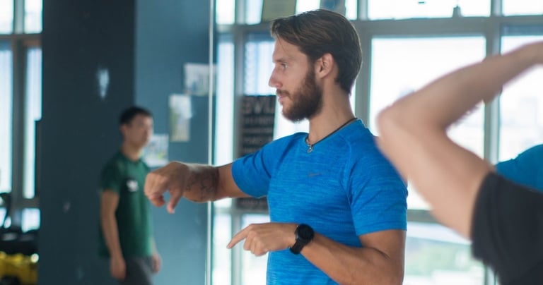 a man in a blue shirt is coaching movement