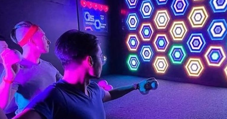 a man and woman playing a game of laser light up