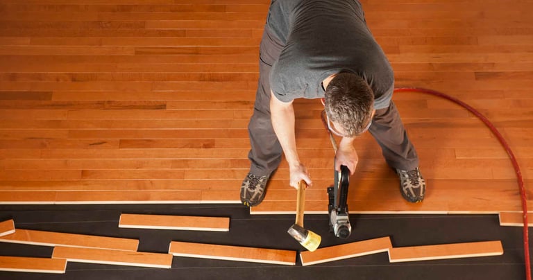 Handyman working on hardwood installation