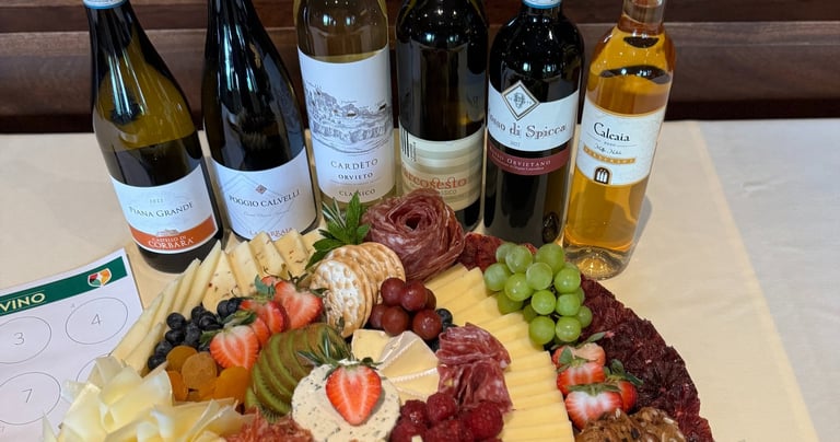 charcuterie on a clothed table with bottles of wine for a consumer tasting