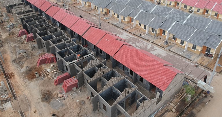 a building with a red roof and a black roof  Distributor Pralon