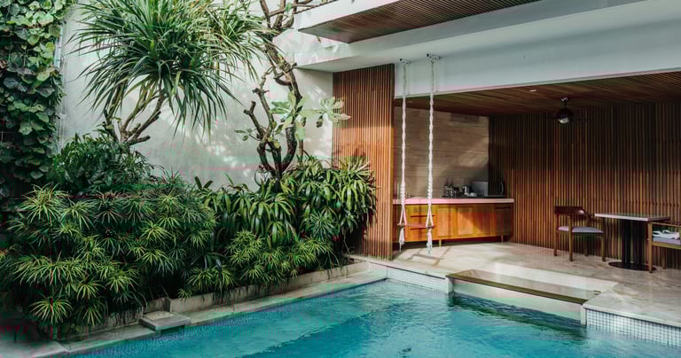 Luxury villa with a private pool on a tropical island, surrounded by lush greenery and scenic views.
