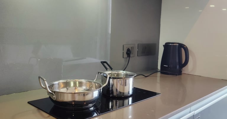 a stove top with all kitchen utensils at Zenith Suites - Noida, Supernova, Supertech