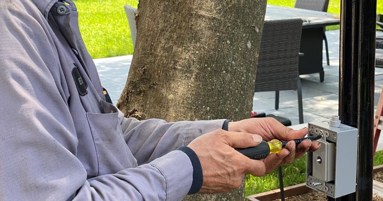 landscape lighting technician installing a dimmer switch