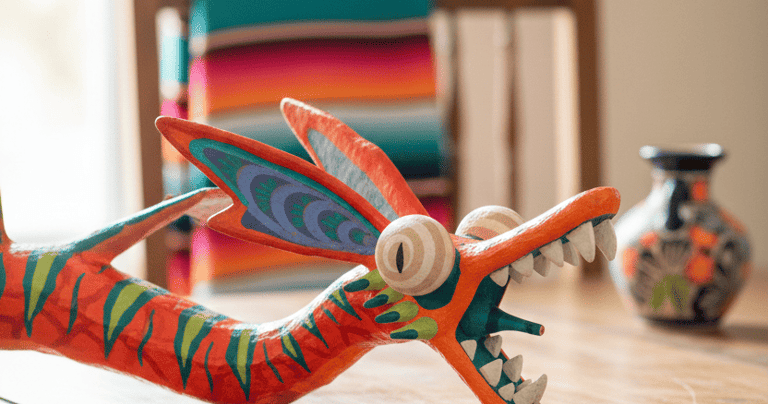 Hand-painted Mexican alebrije dragon folk art sculpture on a wooden dining table.