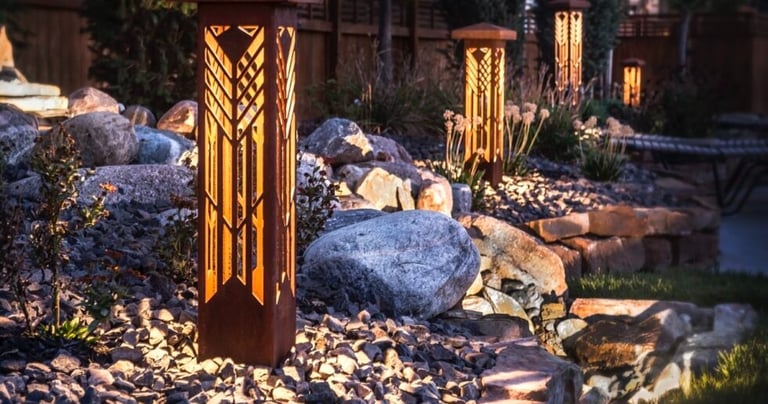 a garden with a wooden post and lights