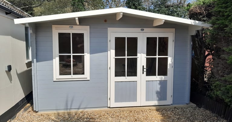 a garden cabin in Poole painted grey and white