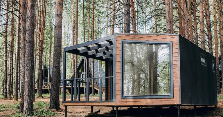 a tiny cabin in the woods with a bicycle