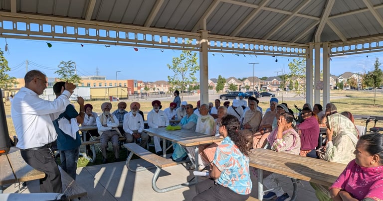 Seniors attending a digital literacy workshop, learning how to use smartphones and online tools.