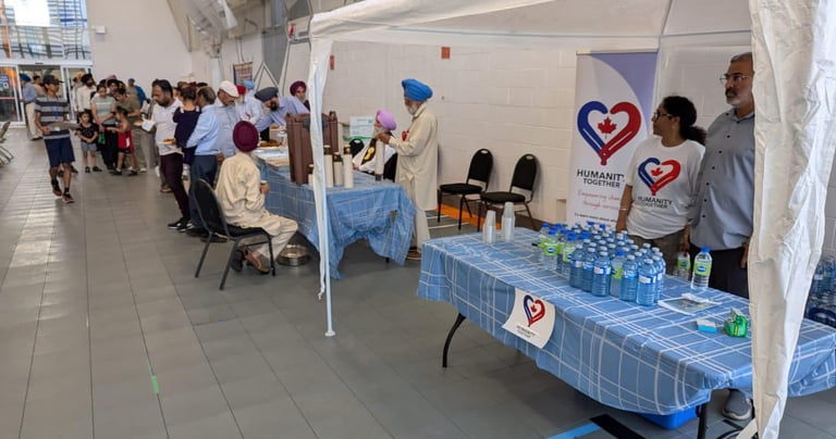 Volunteers hosting a water donation camp at a community event, providing free water to locals